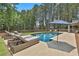 Lush backyard featuring a sparkling pool, lounge chairs for sunbathing, and a privacy fence, great for outdoor living at 33 Vinery Ct, Sharpsburg, GA 30277