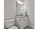 Half-bathroom with granite countertop, white cabinets, and grey walls at 33 Vinery Ct, Sharpsburg, GA 30277