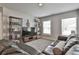 Spacious bonus room with a large screen TV, stylish decor, and two windows at 33 Vinery Ct, Sharpsburg, GA 30277