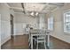 Bright dining room featuring a coffered ceiling, wainscoting, and a chandelier over a table at 33 Vinery Ct, Sharpsburg, GA 30277