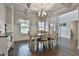 Dining room with dark hardwood floors, coffered ceilings, and bright, natural light at 33 Vinery Ct, Sharpsburg, GA 30277