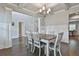 Open concept dining room with coffered ceilings and hardwood floors at 33 Vinery Ct, Sharpsburg, GA 30277