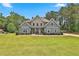 Charming two-story home with stone accents, lush lawn and mature landscaping at 33 Vinery Ct, Sharpsburg, GA 30277