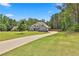 Charming two-story home with a lush green lawn and long driveway at 33 Vinery Ct, Sharpsburg, GA 30277