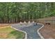 Cozy backyard fire pit area with Adirondack chairs and a stone-lined walkway, great for relaxing evenings at 33 Vinery Ct, Sharpsburg, GA 30277