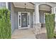Elegant front door with stone accents and well-manicured shrubs at 33 Vinery Ct, Sharpsburg, GA 30277