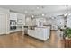 Open concept kitchen with granite countertops, island with a sink, and stainless steel appliances at 33 Vinery Ct, Sharpsburg, GA 30277