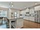 Modern kitchen with granite countertops, stainless steel appliances, and a large center island at 33 Vinery Ct, Sharpsburg, GA 30277