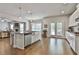 Open-concept kitchen with a center island, stainless steel appliances, and hardwood flooring at 33 Vinery Ct, Sharpsburg, GA 30277