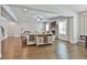 Open-concept living room featuring hardwood floors, large windows, and a stone fireplace at 33 Vinery Ct, Sharpsburg, GA 30277
