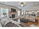 Spacious living room with hardwood floors, stone fireplace, and modern decor at 33 Vinery Ct, Sharpsburg, GA 30277