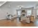 Open-concept living room with stone fireplace and hardwood flooring at 33 Vinery Ct, Sharpsburg, GA 30277