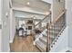 View of living room from staircase featuring hardwood floors and stone fireplace at 33 Vinery Ct, Sharpsburg, GA 30277