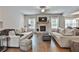 Spacious living room featuring a stone fireplace and hardwood floors at 33 Vinery Ct, Sharpsburg, GA 30277