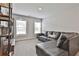 Loft space featuring a comfortable leather sofa and natural light from two windows at 33 Vinery Ct, Sharpsburg, GA 30277