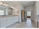 Elegant main bathroom with double vanity, granite countertops, and tile flooring at 33 Vinery Ct, Sharpsburg, GA 30277