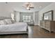 Cozy main bedroom with hardwood floors, a ceiling fan, and an abundance of natural light at 33 Vinery Ct, Sharpsburg, GA 30277
