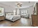 Serene main bedroom with hardwood floors, natural light, and elegant furnishings at 33 Vinery Ct, Sharpsburg, GA 30277
