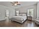 Spacious main bedroom with hardwood floors, ceiling fan and light, and a seating area at 33 Vinery Ct, Sharpsburg, GA 30277