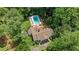 Aerial view of a home featuring a swimming pool surrounded by lush, mature trees at 5545 Cross Gate Ct, Atlanta, GA 30327