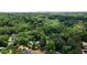 Aerial view showing lush greenery, a home with a pool, and the city skyline in the distance at 5545 Cross Gate Ct, Atlanta, GA 30327