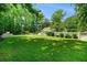 Expansive green backyard featuring a swimming pool, mature trees, and well-kept lawn at 5545 Cross Gate Ct, Atlanta, GA 30327