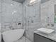 Spa-like bathroom with a freestanding tub, marble walls, and a glass-enclosed shower at 5545 Cross Gate Ct, Atlanta, GA 30327