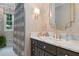 Stylish bathroom featuring marble countertops, dark wood vanity, and elegant wallpaper at 5545 Cross Gate Ct, Atlanta, GA 30327