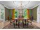 Traditional dining room with hardwood floors, rug, and elegant chandelier with views to outside at 5545 Cross Gate Ct, Atlanta, GA 30327