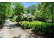 Long driveway leading up to a home surrounded by lush greenery at 5545 Cross Gate Ct, Atlanta, GA 30327