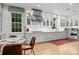 Bright eat-in kitchen with white cabinets, marble countertops, stainless steel appliances and hardwood flooring at 5545 Cross Gate Ct, Atlanta, GA 30327
