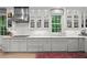 Kitchen boasting white cabinets, marble countertops, and a stainless steel range hood at 5545 Cross Gate Ct, Atlanta, GA 30327