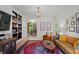 Elegant living room includes a built-in bookcase, leather couch and decorative light fixture at 5545 Cross Gate Ct, Atlanta, GA 30327