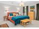 Bright, stylish bedroom with a blue bedspread, colorful pillows, and ample natural light at 5545 Cross Gate Ct, Atlanta, GA 30327