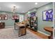 A home office with hardwood floors, wood desk, open shelving and lots of natural light at 5545 Cross Gate Ct, Atlanta, GA 30327
