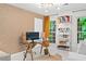 Bright home office featuring a glass desk, ample storage, and large windows at 5545 Cross Gate Ct, Atlanta, GA 30327