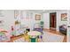 Bright playroom with a polka dot rug, table with colorful chairs, and a variety of toys at 5545 Cross Gate Ct, Atlanta, GA 30327