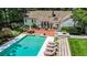 Backyard pool with patio seating, outdoor lounge area, and lush landscaping behind a well-maintained home at 5545 Cross Gate Ct, Atlanta, GA 30327