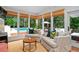 Cozy sunroom with wicker furniture, terracotta floors, and a beautiful view of the pool at 5545 Cross Gate Ct, Atlanta, GA 30327