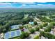 Aerial view of community amenities, including tennis courts, swimming pool, and clubhouse near lush greenery at 5623 Brendlynn Dr, Suwanee, GA 30024