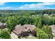 Aerial view of a beautiful estate nestled among lush trees and greenery in a lovely neighborhood at 5623 Brendlynn Dr, Suwanee, GA 30024