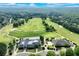 Scenic aerial view of a meticulously landscaped golf course, clubhouse and lush green fairways in the community at 5623 Brendlynn Dr, Suwanee, GA 30024
