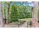 Landscaped backyard with lush greenery, walkway with railings and a sense of privacy at 5623 Brendlynn Dr, Suwanee, GA 30024