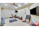 Basement home gym with mounted televisions and workout gear at 5623 Brendlynn Dr, Suwanee, GA 30024