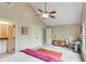 Spacious bedroom with ceiling fan, natural light, and desk area for work or study at 5623 Brendlynn Dr, Suwanee, GA 30024