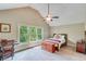 Bedroom with natural light, desk, and ceiling fan for comfortable living at 5623 Brendlynn Dr, Suwanee, GA 30024