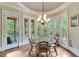 Sun-drenched breakfast nook with bay windows and access to a private deck overlooking the trees at 5623 Brendlynn Dr, Suwanee, GA 30024