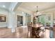 Bright dining area with detailed trim, chandelier, and French doors to the backyard at 5623 Brendlynn Dr, Suwanee, GA 30024