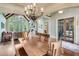 Formal dining room with vaulted ceiling, stone fireplace, and views into office at 5623 Brendlynn Dr, Suwanee, GA 30024