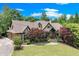 Charming two-story home with beautiful lawn and landscaped yard with brick and stone exterior accents at 5623 Brendlynn Dr, Suwanee, GA 30024